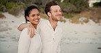 Interracial, couple and walk at beach outdoor of summer vacation, bonding together and ocean trip. Smile, people and embrace for journey of holiday getaway, relationship commitment and date adventure