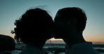 Couple, kiss and silhouette with beach sunset for summer vacation, bonding together and affection. People, support and care with holiday getaway, relationship commitment and date adventure of evening