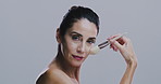 Brush, makeup and face of woman on gray background for wellness, beauty and cosmetics in studio. Cosmetology, skincare and mature person with tools for facial application, salon and spa products