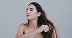 Haircare, woman and styling hair with brush for scalp stimulation, healthy growth or split ends removal. Beauty, grooming routine or mature person with tool for volume texture on studio background