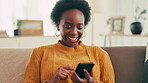 Laughing, online and woman with smartphone, texting and reading of message on social media and house. Typing, relax and communication with contact in living room, funny and black person with mobile