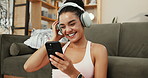 Happy woman, fitness and listening with headphones for audio streaming, music or podcast at home. Active, female person or smile with mobile smartphone for online subscription or radio app at house