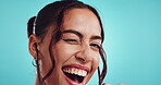 Girl, face and wink with sunglasses in studio for flirting, romantic greet and fun personality. Woman, happy and designer heart shades with secret eye contact, goofy and confidence on blue background