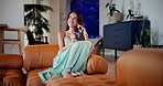 Happy woman, phone and relax with coffee on sofa for thoughtful morning, chat or listening with voice note at home. Female person, user and smile with mobile smartphone or caffeine for talk at house