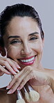 Woman, happy and face in studio with makeup brush, cosmetics and confidence with beauty. Mature person, closeup or smile on white background with facial tools, skincare and cosmetology with aesthetic
