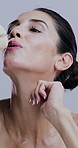 Beauty, blow and flower with mature woman in studio for antiaging or natural cosmetics routine. Aesthetic, skincare and smile with model on white background for dermatology, grooming or wellness