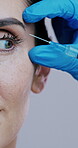 Beauty, hands and face of woman with syringe for dermal injection, cosmetic filler or transformation. Professional, gloves or needle for collagen implant or anti aging treatment on studio background