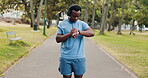 Fitness, music and time with black man in park for start of cardio training, marathon or running. Exercise, monitor and watch with athlete or runner person tracking progress of outdoor workout