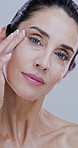 Cream, beauty and face of mature woman for skincare, wellness and facial care on white background. Dermatology, touch and portrait of person for anti aging, collagen and cosmetics products in studio