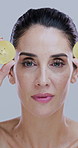 Skincare, kiwi and face of mature woman in studio for beauty, natural cosmetic and facial on white background. Dermatology, health and portrait of person with fruit for detox, vitamins or antioxidant