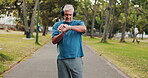 Fitness, music and watch with man in park for start of cardio training, marathon or running. Exercise, monitor and time with mature athlete or runner person tracking progress of outdoor workout