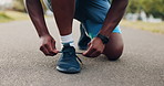 Person, hands or tie shoes with laces on asphalt for walk, run or workout at outdoor park. Closeup, active or runner with sneaker or tying for cardio training or fitness preparation on street or road
