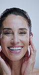 Woman, face and skincare in studio for dermatology, treatment and collagen benefits for anti aging. Portrait, beauty model and mature person with happiness for cosmetics, glow and white background