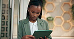 Creative, black woman and typing with tablet in office for project management, client feedback or email review. Interior designer, app and planning for home remodeling, research or decoration website