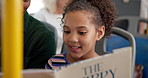 Travel, book and father with kid on bus reading together for entertainment, bonding and connection. Happy, fantasy and girl child with dad for storytelling with commuting on public transport together