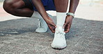 Runner, hands and ankle pain at in street with injury, fatigue and sprain with inflammation in city. Person, athlete and outdoor for fitness, workout and exercise with joint ache on sidewalk in Kenya