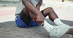 Runner, hands and calf pain at in street with injury, fatigue and sprain with inflammation in city. Person, athlete and legs for fitness, workout and exercise with muscle ache on sidewalk in Kenya