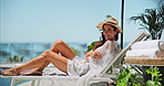 Sunbathing, relax and woman on holiday, laughing and summer vacation for tourist, hotel or outdoor. Travel, resting and person at resort, trip or break for traveller, comfortable or smile for getaway