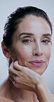 Skincare, woman and face in studio for cosmetics, treatment and collagen benefits for anti aging. Portrait, beauty model and mature person with confidence for dermatology, glow and white background