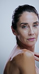 Shoulder, beauty and face of mature woman in studio for grooming, hygiene and wellness. Dermatology, skincare and portrait of person for body health, natural texture and hydration on white background