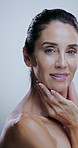 Woman, face and smile in studio for skincare, treatment and collagen benefits for anti aging. Portrait, beauty model and mature person with confidence for cosmetics, glowing skin and white background