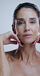 Skincare, mature and face of woman in studio for anti aging, cosmetics and wrinkle treatment. Dermatology, touch and portrait of person for beauty, wellness and glow of natural texture on background