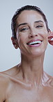 Studio, skincare and mature happy woman for anti aging cosmetics, results and face transformation. Dermatology, spa and portrait of person for facial, wellness and natural texture on white background