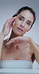 Woman, skincare and touch face in studio with results, check and transformation by background. Mature person, model and process in portrait for cosmetics, glow and change with anti aging in Italy