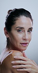 Shoulder, skincare and face of woman in studio for grooming, hygiene and wellness. Dermatology, portrait and mature person with beauty for health, natural texture and hydration on white background