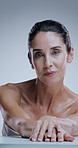 Mature woman, cosmetics and face in studio with results, beauty and transformation by background. Person, model and process in portrait for skincare, change and benefits for anti aging in Argentina