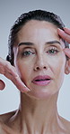 Skincare, mature and woman in studio with touch for anti aging, cosmetics and wrinkle treatment. Dermatology, spa and portrait of person for beauty, facial and health of natural texture on background