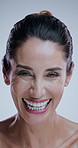 Woman, skincare and face with laugh in studio with beauty, happy and results by background. Mature person, model and funny in portrait with cosmetics, glow and anti aging transformation in Argentina