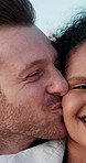 Kiss, travel and couple on holiday, romance and people in relationship on getaway, outdoor and care. Bonding, man and love for woman on vacation, honeymoon and smile for trip with valentines day