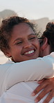 Love, couple and happy with hugging at beach for travel adventure, romantic holiday or honeymoon trip. People, embrace and laughing together by seaside for funny conversation, bonding or relationship