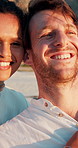 Travel, happy and couple with love by beach for honeymoon vacation, ocean breeze and sightseeing nature. Interracial people, smile and romantic weekend by seaside for anniversary, support and bonding