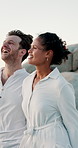 Beach, couple and walking with holding hands for holiday, travel and memory for valentines day. Ocean, man and woman with love embrace for healthy relationship, bonding and vacation for anniversary
