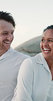 Walking, laughing or happy couple at beach for valentines day, love or romance in interracial relationship. Hug, vacation or people bonding on holiday for romantic honeymoon, embrace and travel date