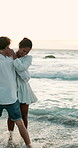 Playing, hug or happy couple in water at sea for valentines day or love in interracial relationship. Embrace, splash or people bonding at beach on holiday for romantic honeymoon, vacation and date