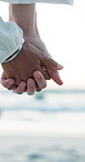Holding hands, closeup or couple at beach for valentines day, love romance or committed relationship. Sea, vacation or people bonding on holiday for romantic honeymoon, care or travel date together
