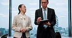 Business, people and walk with tablet in office for planning schedule, research advice and negotiation. Staff, talking and digital for finance budget, investment feedback and proposal report in Japan