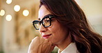 Happy woman, night and thinking with glasses for online booking or travel application at agency. Female person, consultant or reservation agent with smile, thought or wonder for trip or schedule