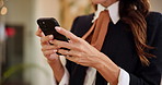 Woman, hands and typing with phone at hotel for online booking, schedule or checking reservation. Closeup, female person or concierge texting with mobile smartphone for communication at luxury resort