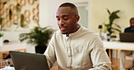 Black man, smile and typing with laptop in office, news and proofreading for creative agency. Review, male person and journalist with digital for business story, editing and website for publication