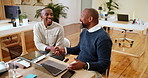 Happy, businessmen and handshake with laptop for thank you, project agreement or deal together at office. Male people, coworkers or shaking hands with computer for partnership, meeting or teamwork