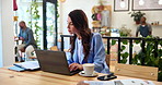 Coffee shop, documents and business woman on laptop for research, website and online for project management. Cafe, freelance consultant and person on computer for proposal, review and remote work
