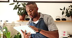 Online order, stock and tablet with black man in coffee shop for booking or management of small business. Ecommerce, internet and seating plan with waiter reading checklist in cafe or restaurant