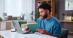 Logistics, tablet and man on laptop for small business, order review and comparison in home. Ecommerce, distribution and technology for online sales, stock procurement and freelancer typing email