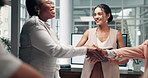 Business people, meeting and handshake with screen for workshop, mental health or employee wellbeing at office. Happy group, team or staff shaking hands with completion for social or training session