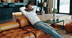 Living room, relax and man in home on sofa for resting, calm and chill on weekend afternoon. House, living room and person with hands on head on couch for confidence, pride and happiness in apartment