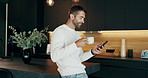 Cellphone, coffee and man in kitchen in morning at home reading online blog for world news report. Cappuccino, phone and male person drinking caffeine latte with politics tabloids in apartment.